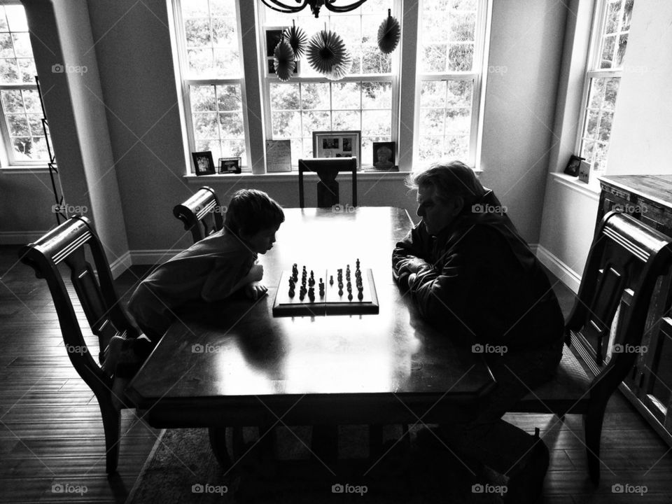 Chess. Boy Playing Chess With Grandpa
