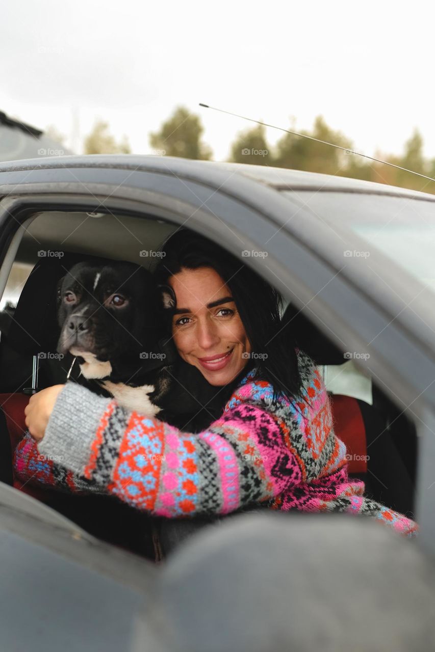 Woman with dog in car 