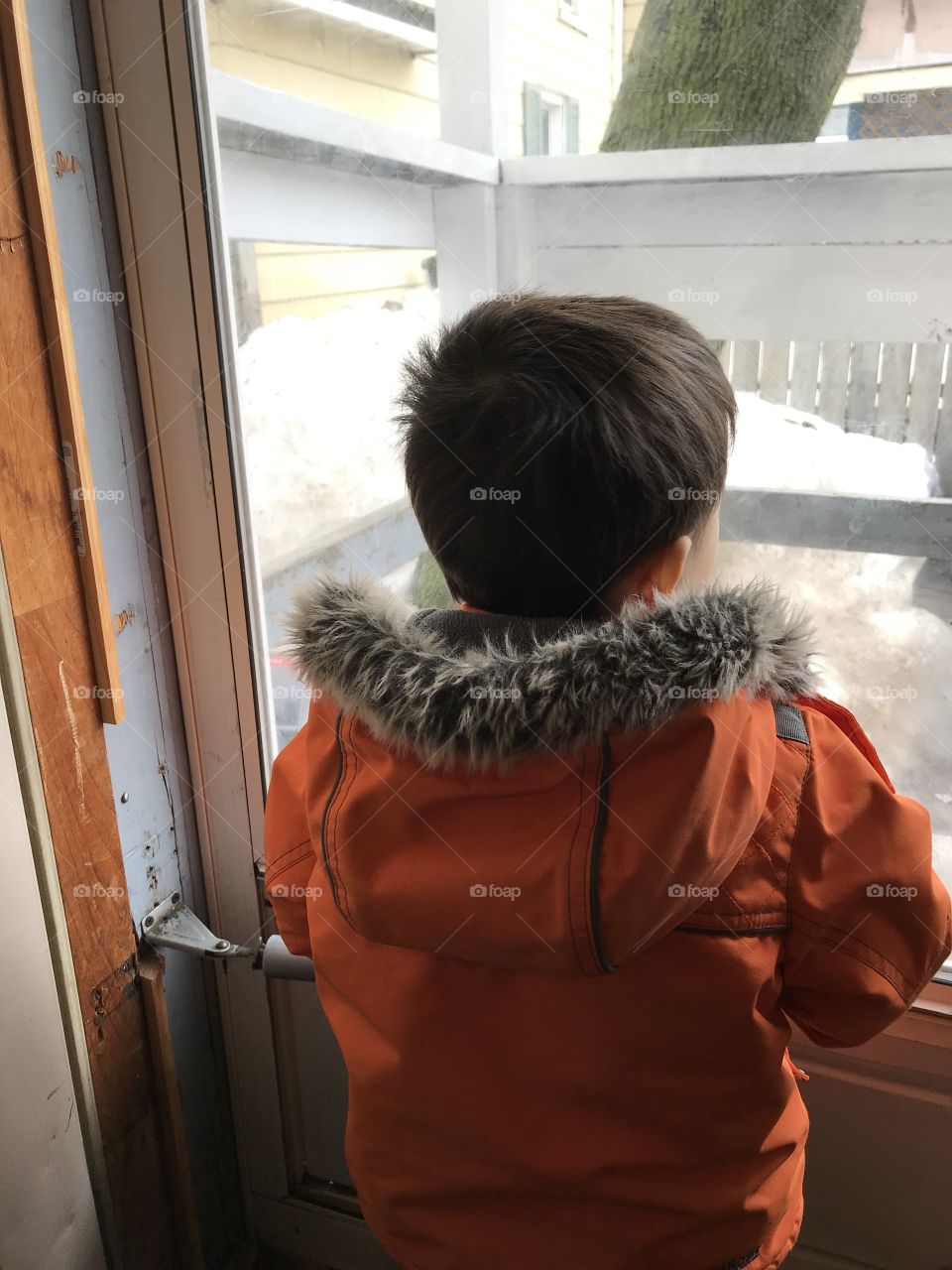 Child looking out door