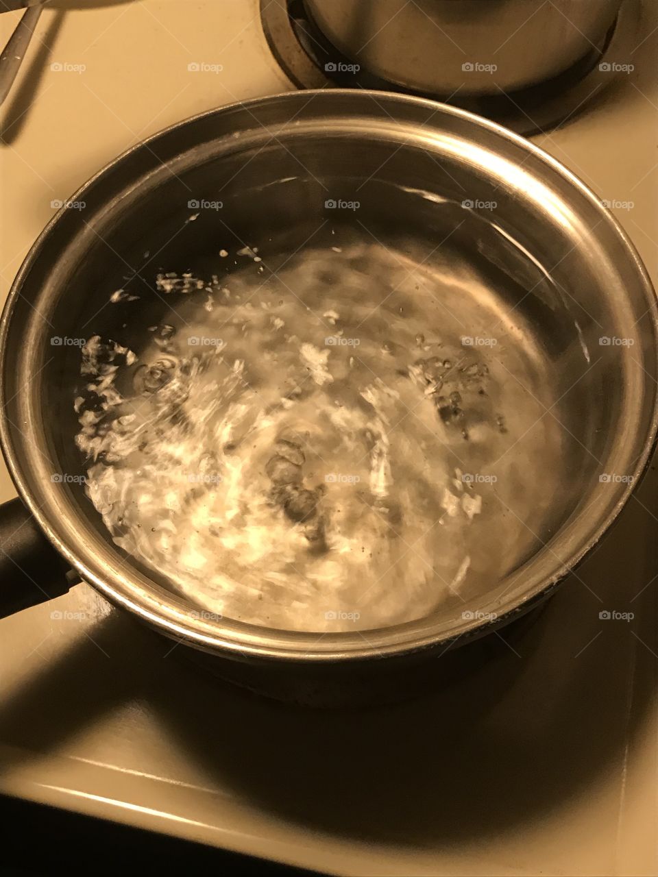 To the boiling point. The water from the faucet is appropriately distilled in the pan to make it drinkable.