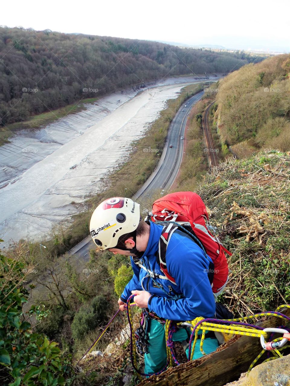 Close-up of man rappelling from mountain