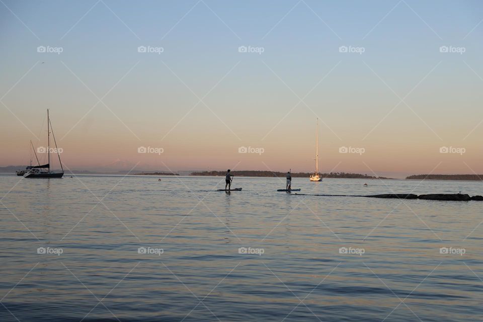 Paddle boarding on sunset