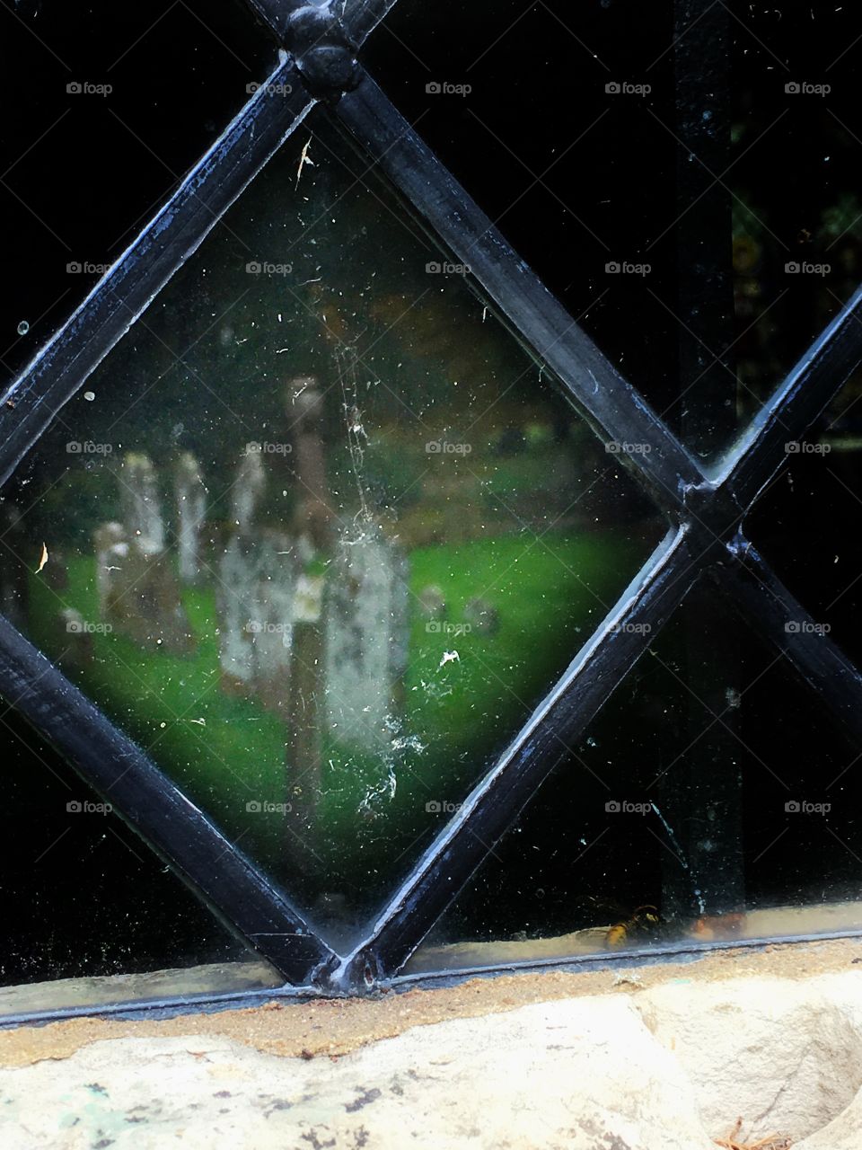 Reflection of a graveyard in a church window