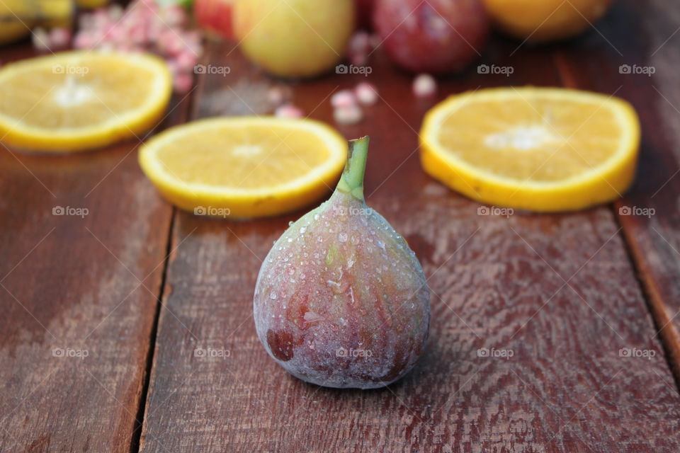 Wet fig on wooden plank