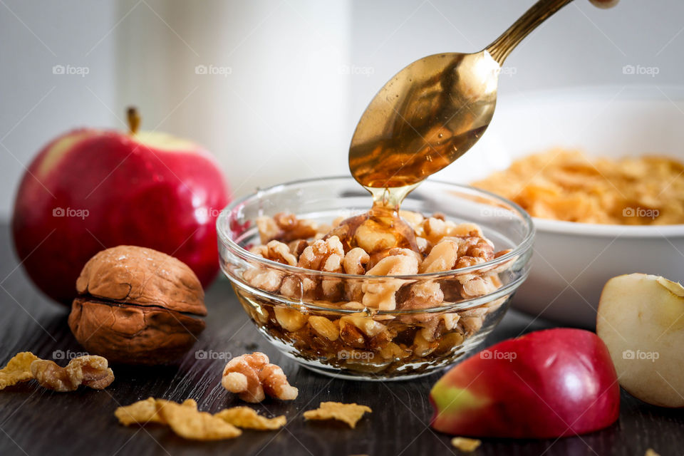 Healthy snacks with apples, nuts and honey