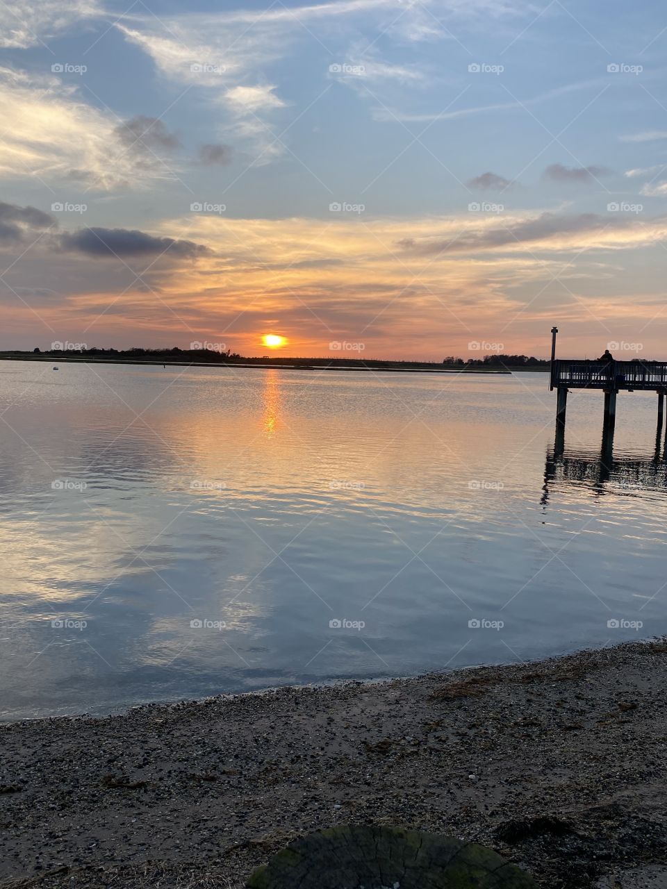 Sunset over water with dock