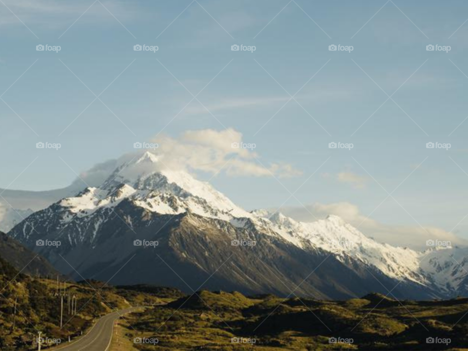 Clouds Scattered Over A Snowcapped Mountain