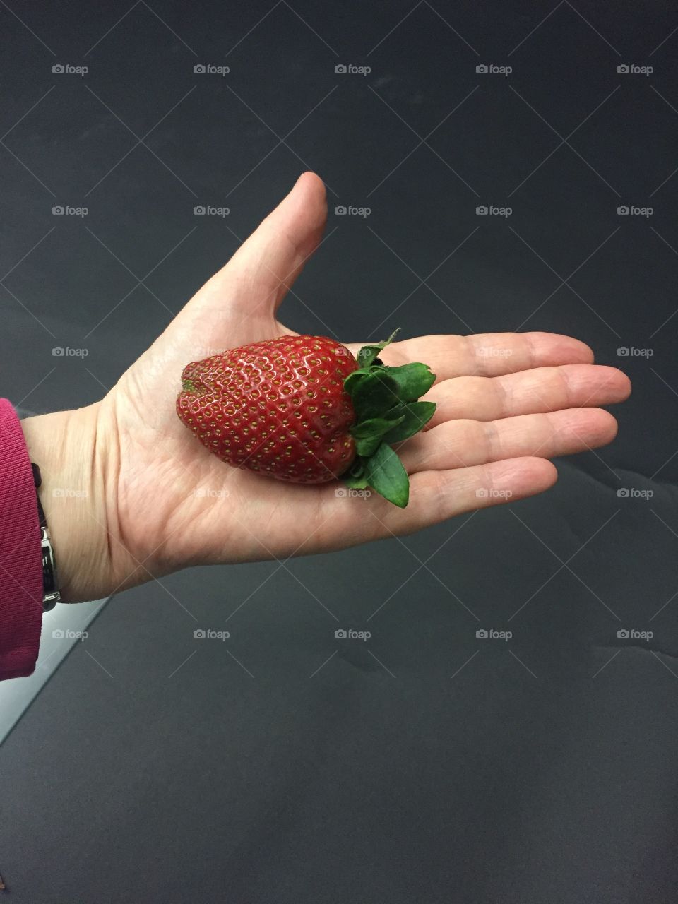 Strawberry in human hand