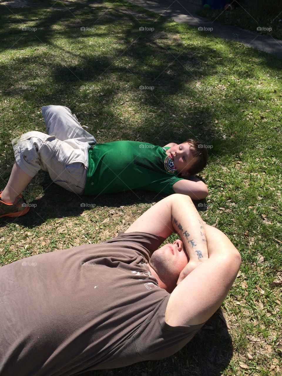 My husband and step son chillaxin in the grass. His son wanted to do everything his daddy was doing. Love this picture of them. Summer time fun memories!