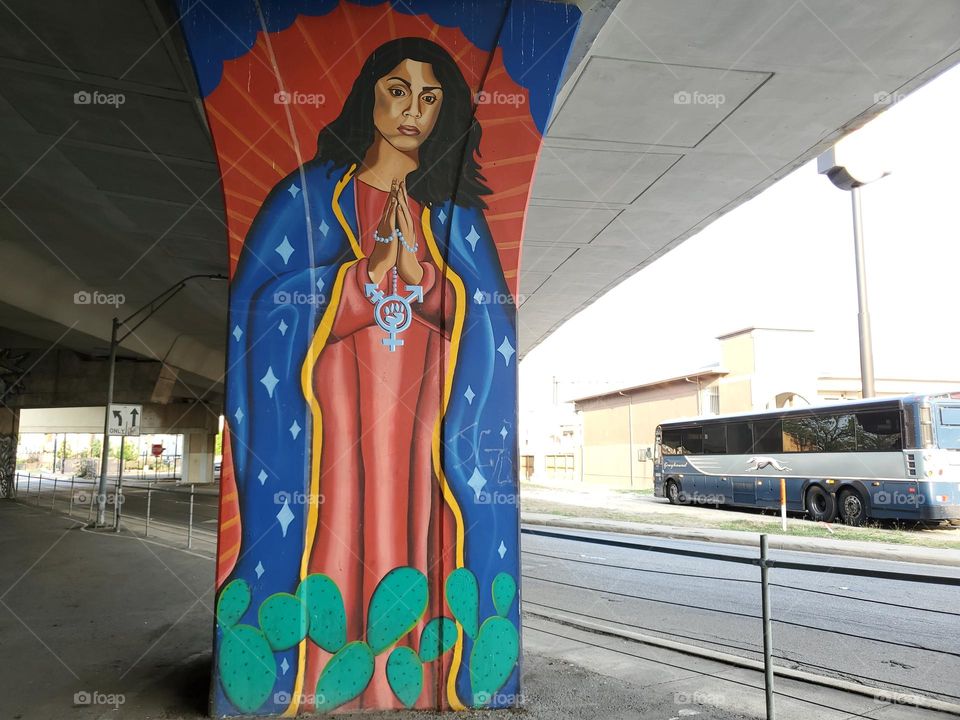 Colorful urban street art under a highway.