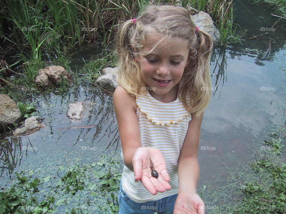 Water conservation- exploring the pond she found a tadpole. 