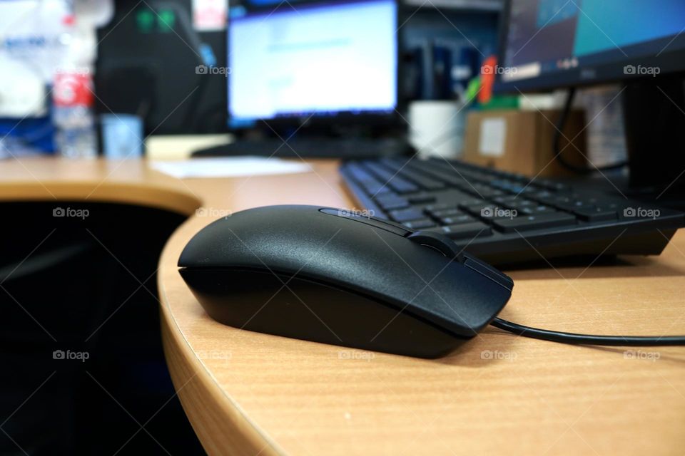 Computer mouse on the office desk, this tool serves to input data or give commands to the processor.