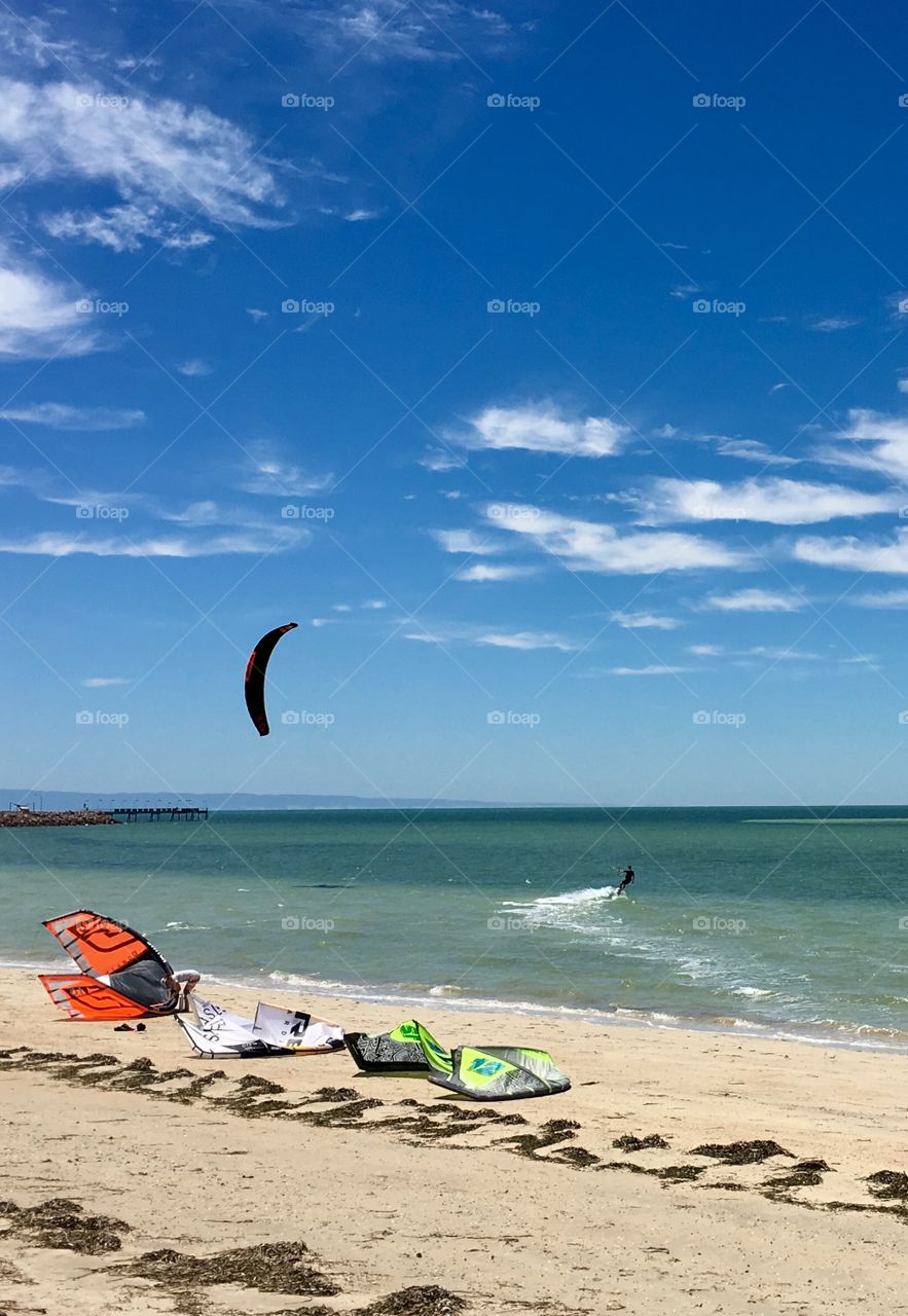 Kiteboarding on a wispy windy summer day at the ocean