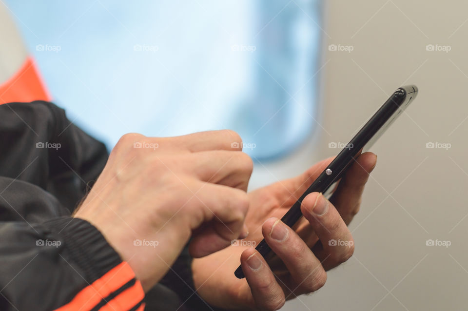 Close up man's hands with smartphone