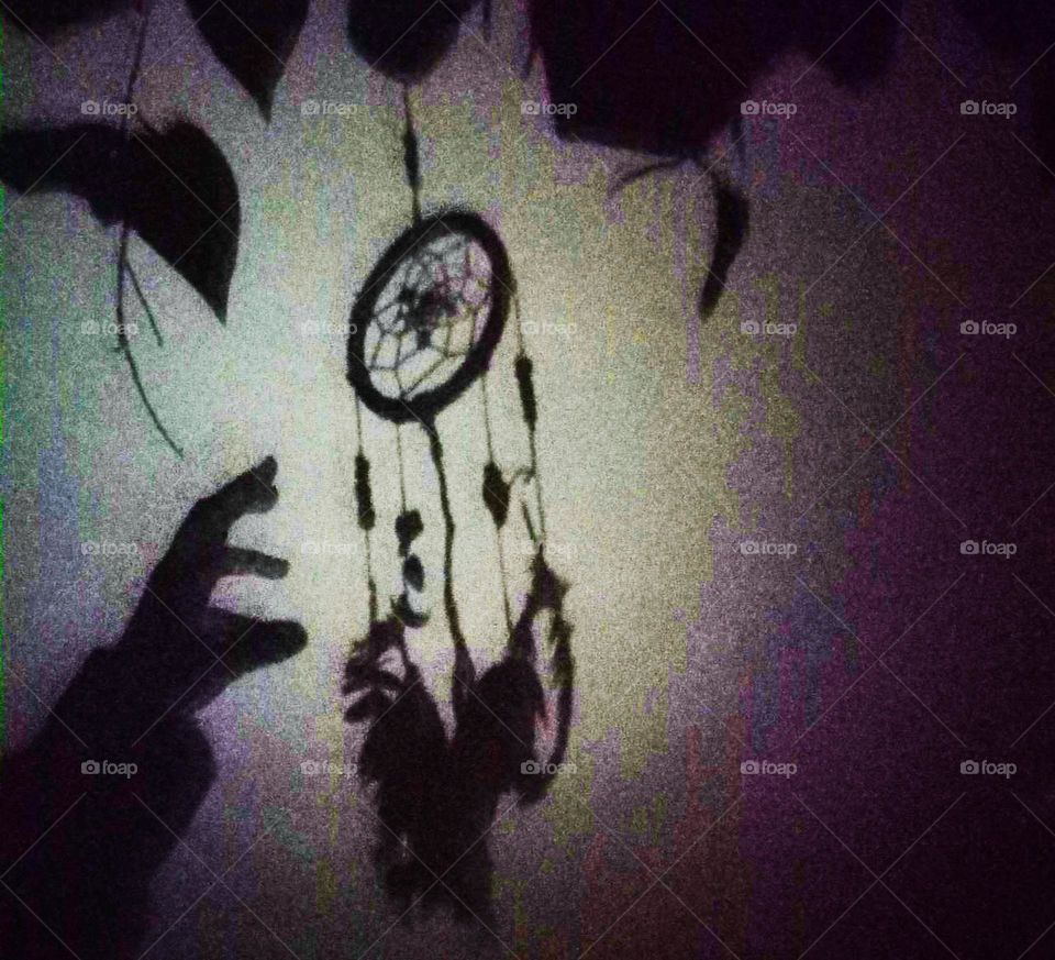 this is a shadow of me and my dream catcher it looks like us trying to reach for good dreams that pass through