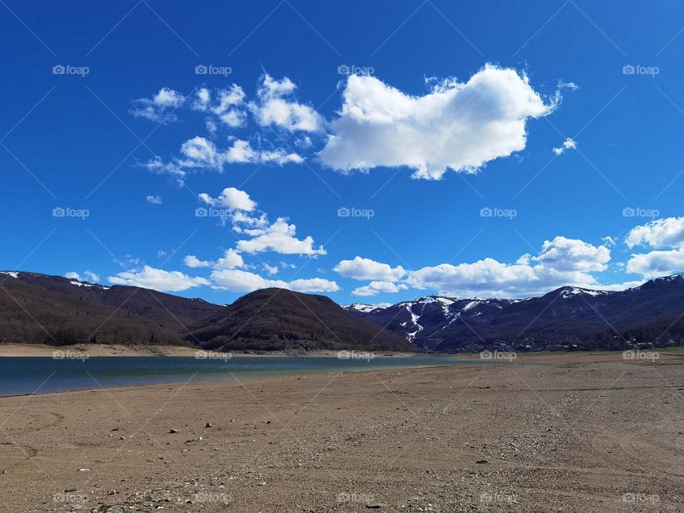 Blue sky beyond mountains