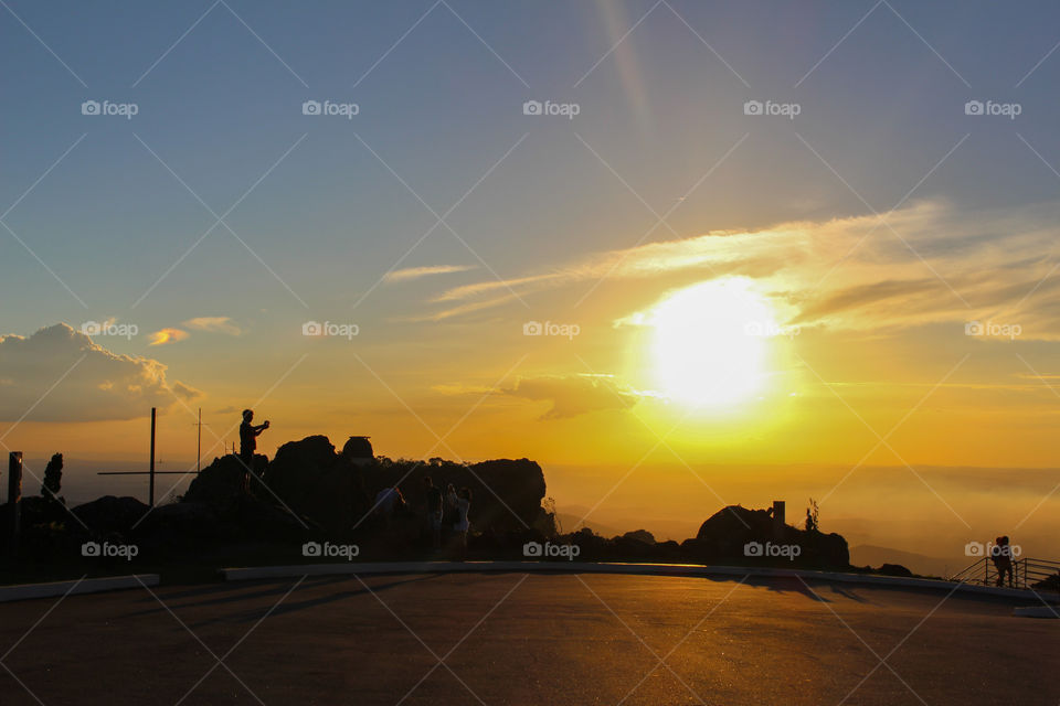 People taking selfie at sunset