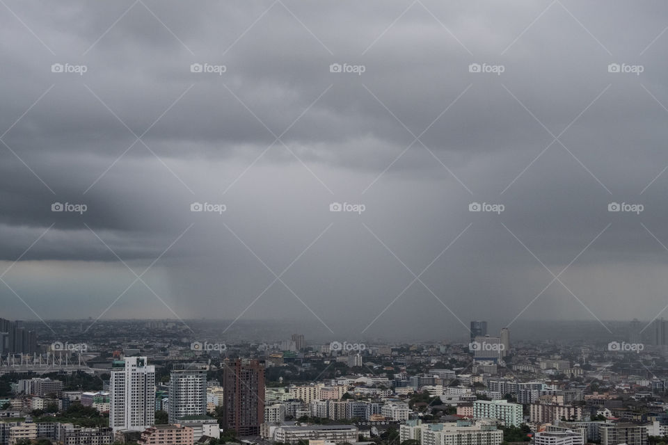 Cloudy float above building in Bangkok before rain