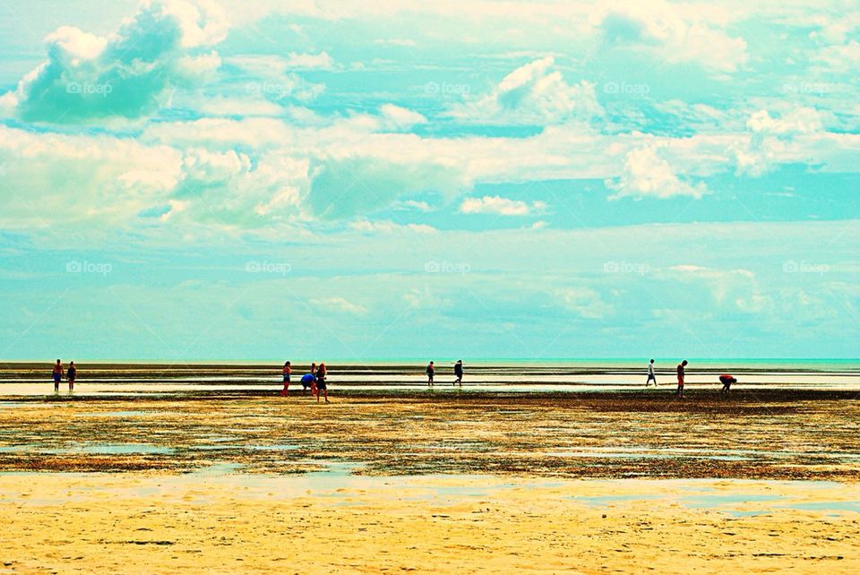 People in a low tide