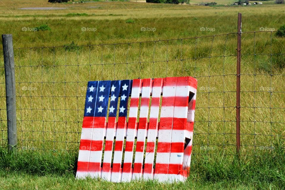 Pallet flag against a fence