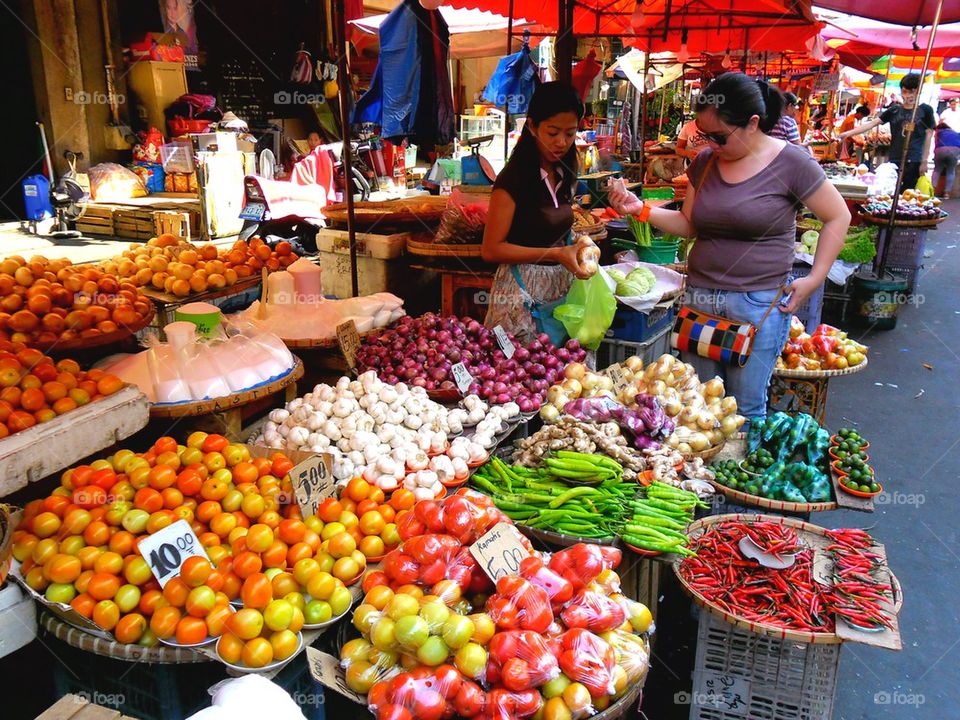 asian street vendor selling fruits and vegetables in quiapo, manila, philippines in asia
