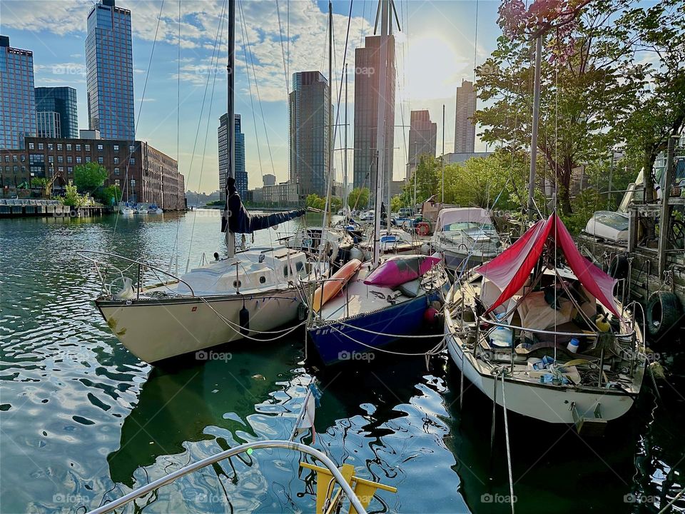 The golden evening sun reflects off the waters of “Newtown Creek” seen from aboard “Salvation”, a “28 foot 1969 Luhrs” cabin cruiser by the “Pulaski Bridge” in LIC, Queens. 2024. Hypnotic Productions
