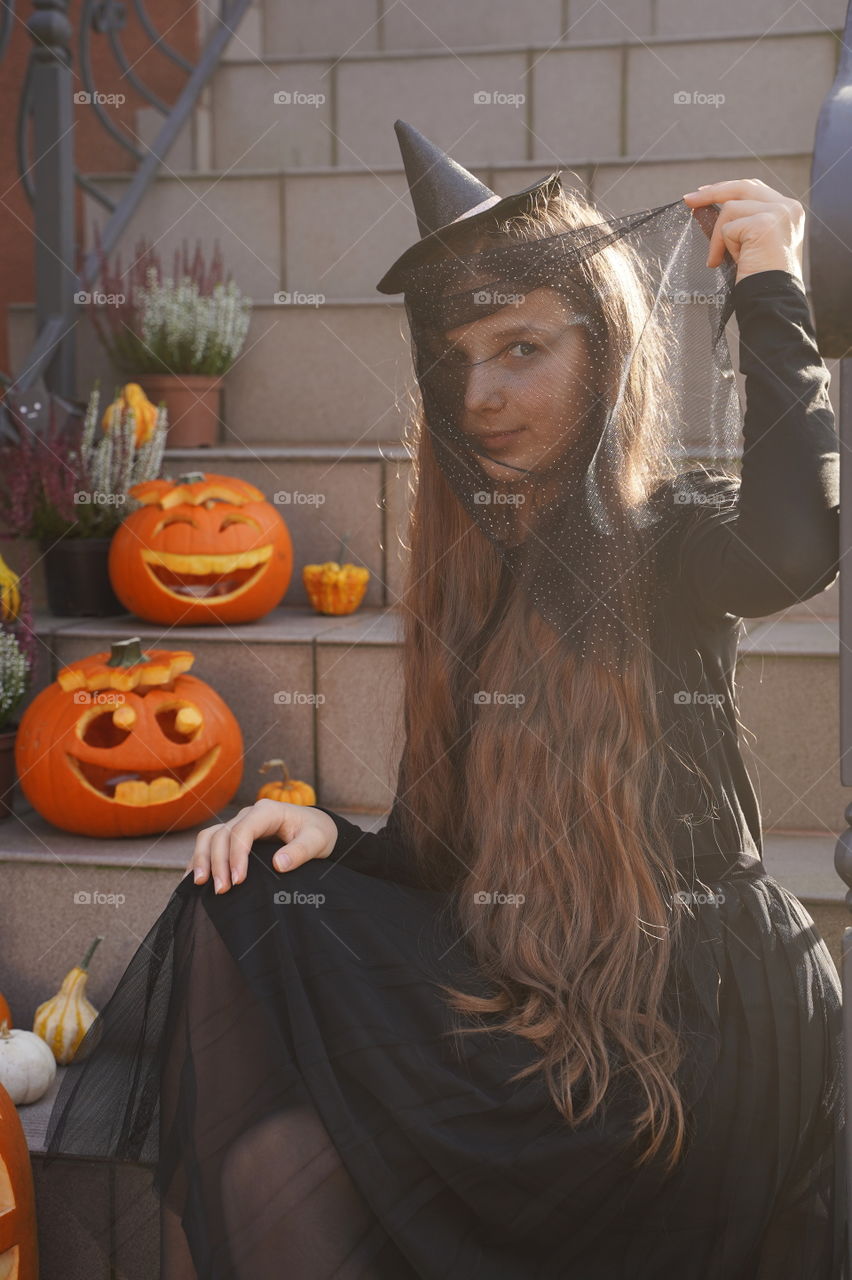 Girl in Halloween witch costumes