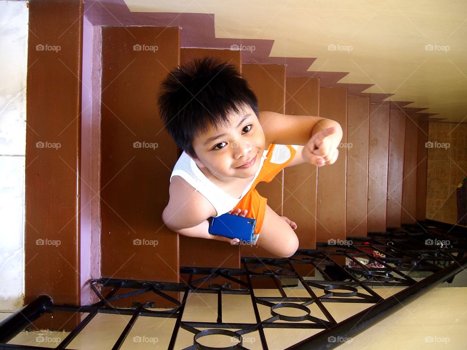 young kid sitting on a set of staircase