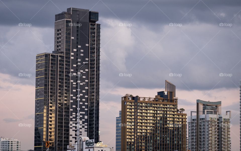 Cloudy sky over skyscraper scape before rain in Bangkok Thailand 