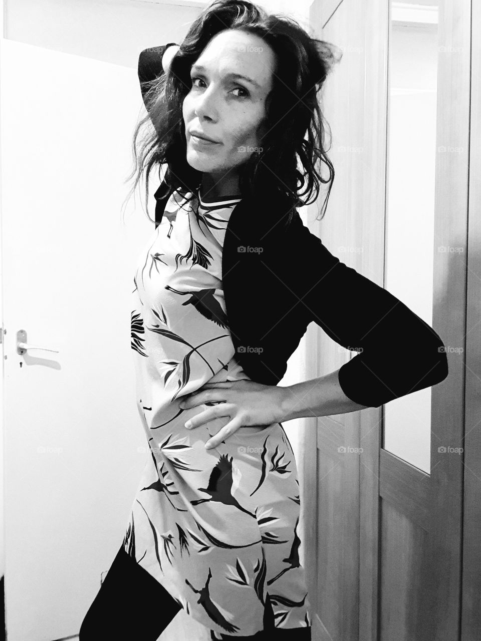 A nice pose by a woman in front of the camera.