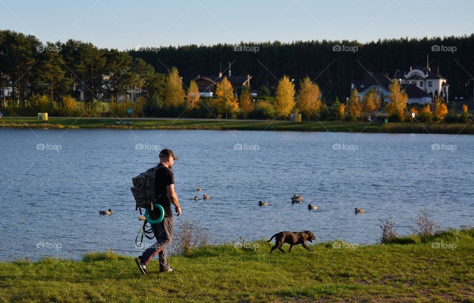 men walking with dog autumn landscape