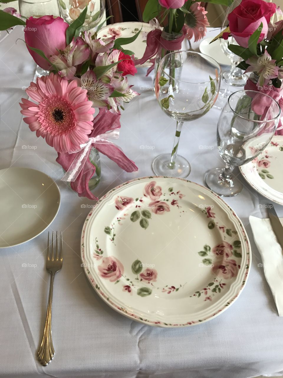 Afternoon tea party with delicious food, flowers plate glasses 