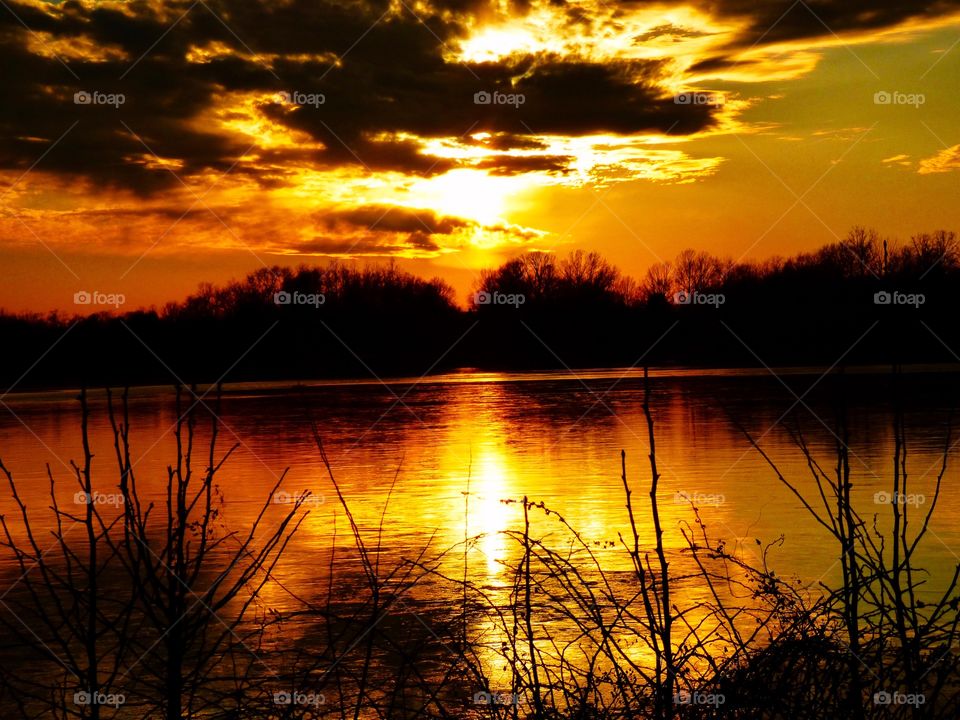 Sunshine and sunset with a cross in sunshine on the lake. 