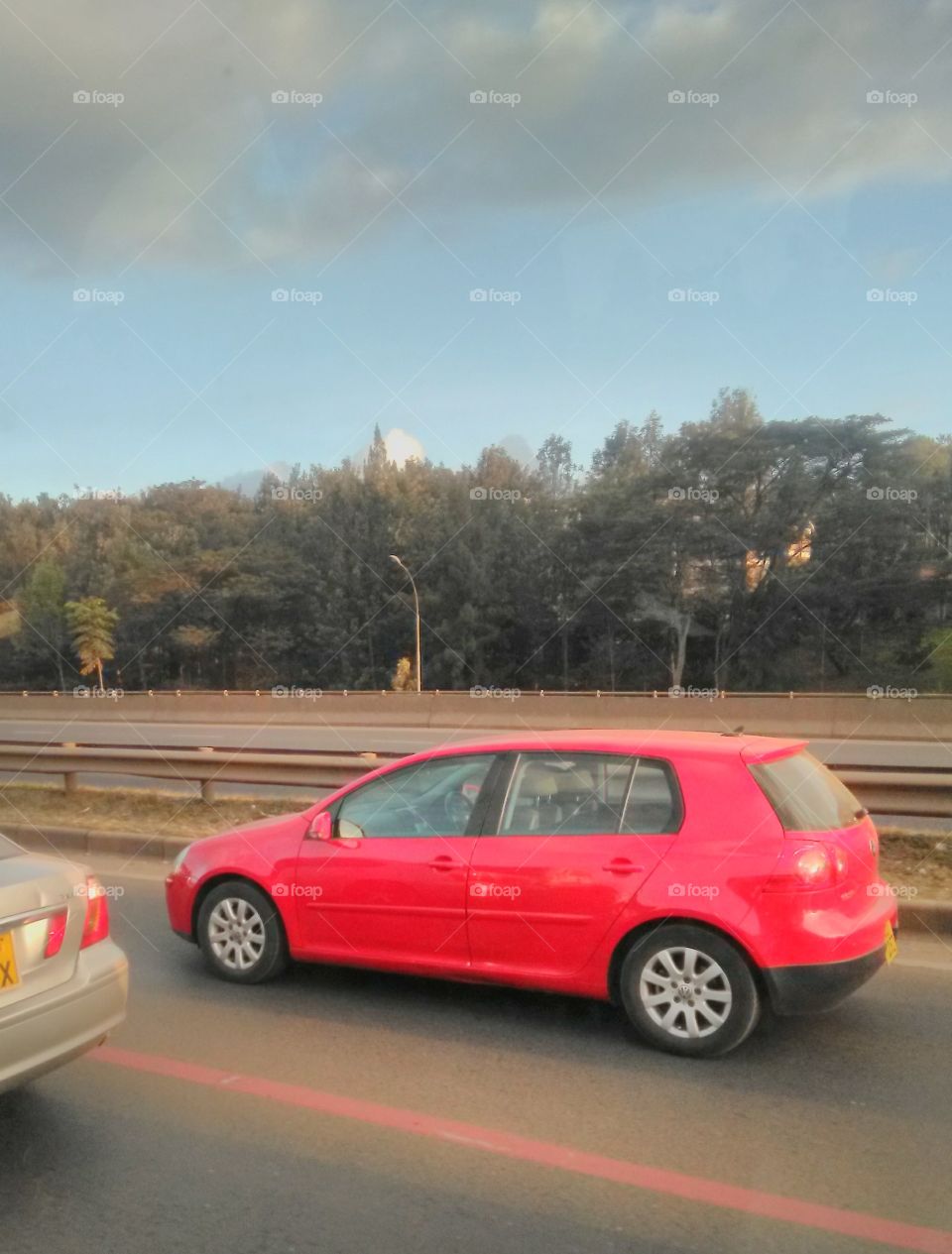 This is a red Volkswagen Golf which is a 4-seater car with an engine capacity ranging from 1400CC onwards.