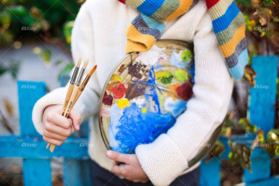 Midsection view of painter with paintbrush