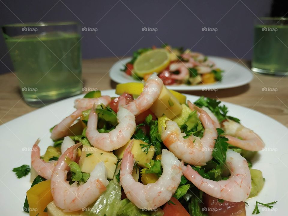 delicious homemade salad with shrimps, cheese, mango and herbs, dressed with citrus sauce