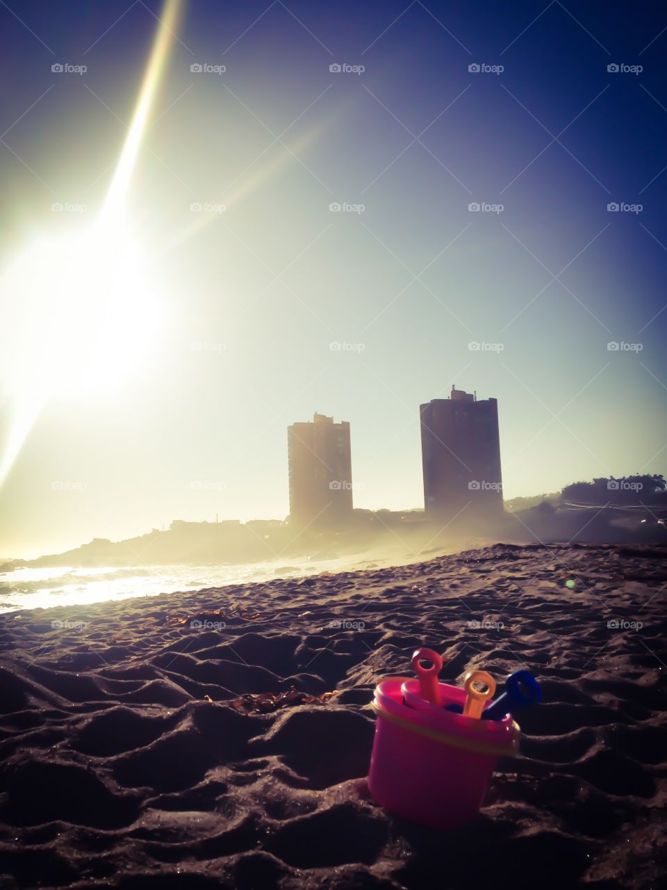 A child toy forgotten . People usually lose and forget things at the beach even the children. 