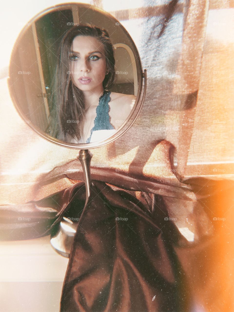 Long hair Brunette looking in mirror on dresser
