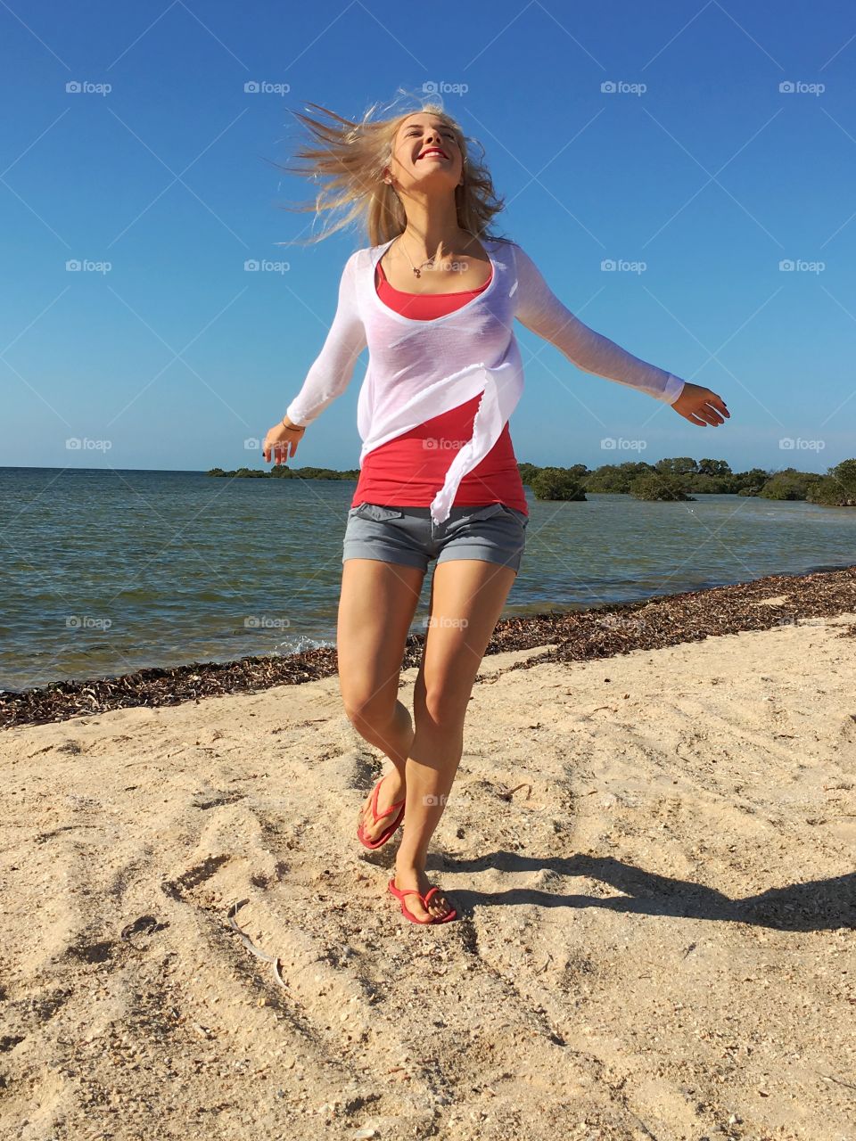 Portrait of cheerful woman at beach