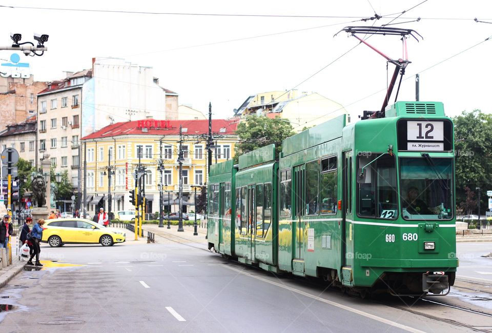 Green tram at the street