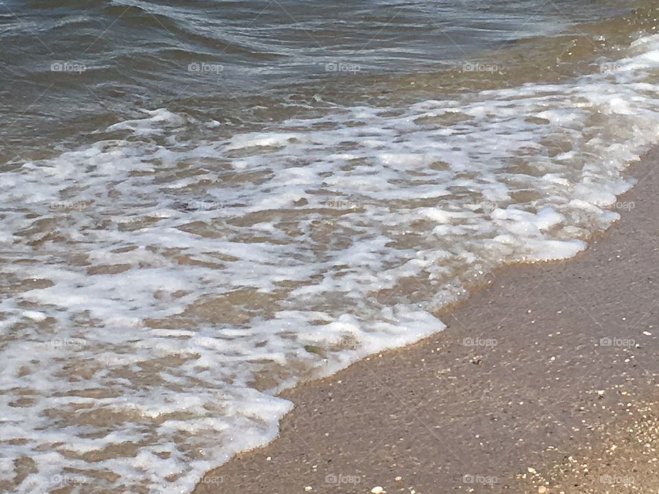 Ocean water waves on the beach.