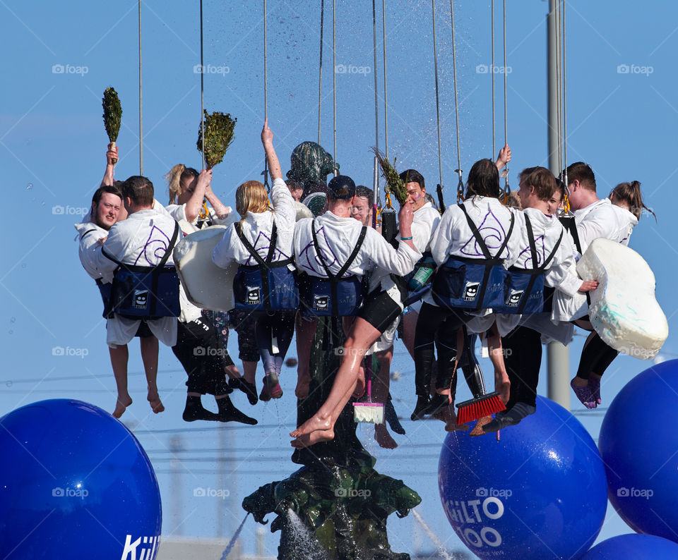 Helsinki, Finland - April 30, 2019: Members of the Aalto University Student Union’s Community section wash and perform traditional spring cleaning to the statue of Havis Amanda in the center of Helsinki as highlight of the Finnish Mayday carnival. 