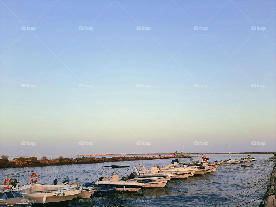Overlooking the island and the row of boats at sunset