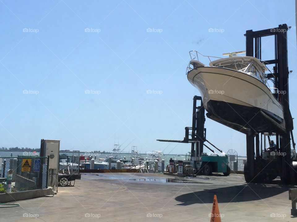 Boat being lifted in to dry storage at a marina