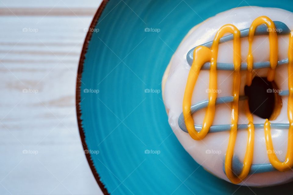 Closeup Of A Frosted Donut On A Teal Plate, Still Life Food Photography 