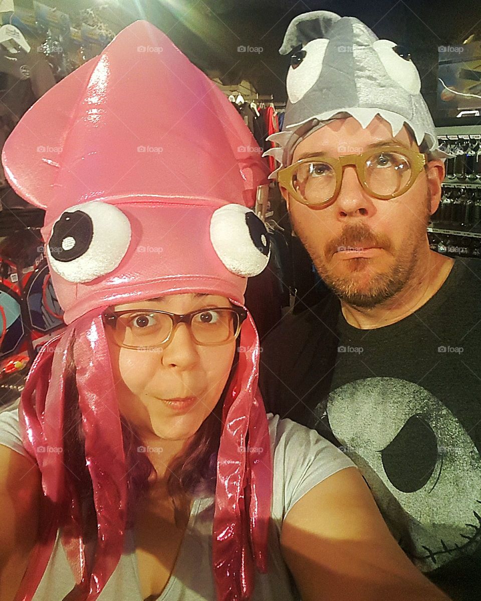 Couple taking selfie wearing animal costume headwear
