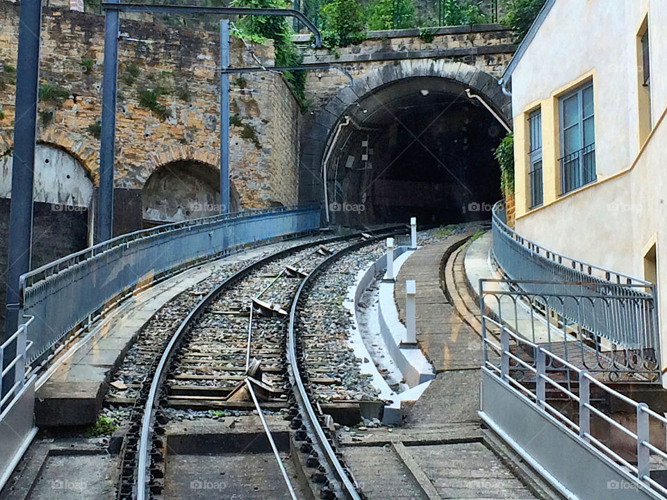 Cable car train tracks go into the tunnel