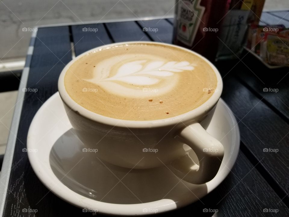 Hot mocha latte with leafy foam art