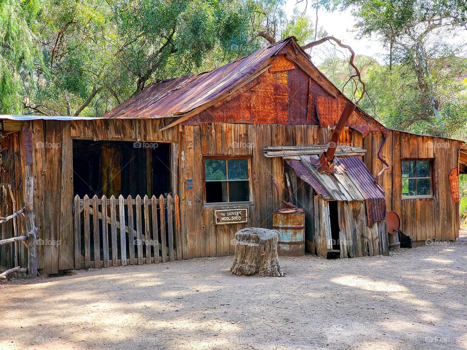 A mock up cabin of an old working sheep shearing camp is patinad with age and exposure to the elements