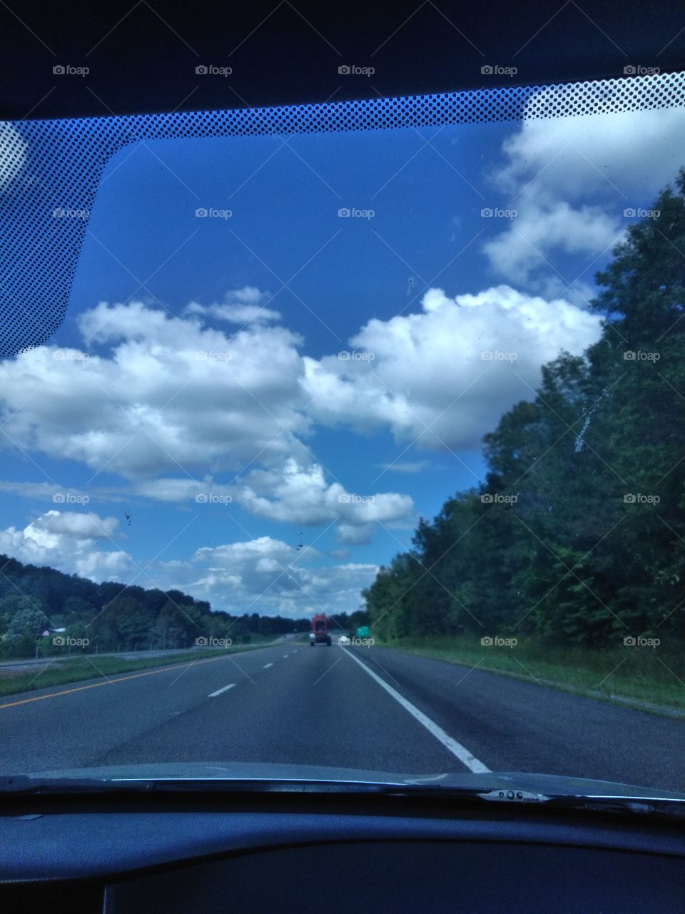 Interstate 26 surrounded by beautiful, blue skies and lush green trees.